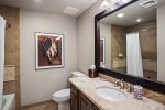 2nd guest bathroom with heated floors and shower/tub combination.